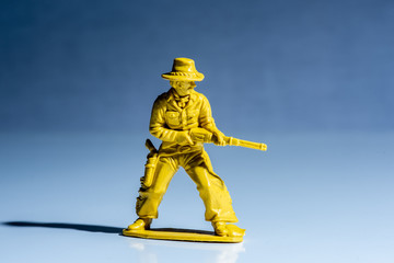 Yellow cowboy plastic toy figure.