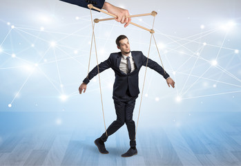 Puppet businessman controlled by another hand with financial concept
