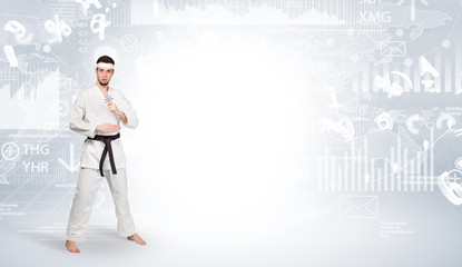 Young karate trainer doing karate tricks on the top of a metropolitan city
