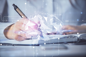 Double exposure of woman's writing hand on background with brain hologram. Concept of brainstorming.