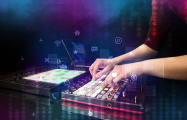 Fototapeta na wymiar Hand mixing music on dj controller with social media concept icons 