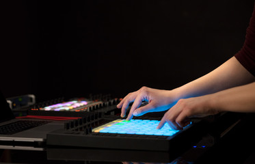 Dj hand remixing music on midi controller
