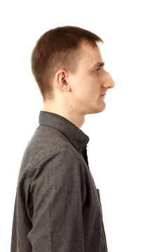 Tall Thin Young Man Stands On White Background In Profile