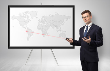 Handsome businessman with laser pointer  presenting potential business area on map
