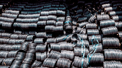 Steel coils in cargo ship, Raw material of steel wire import from oversea by sea shipment, Black carbon wire rode business, Steel roll are loading from ship to truck at pprt terminal