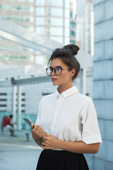 Woman wearing smart casual clothing  is using tablet pc