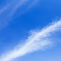 Naklejka na ściany i meble Bright white ripples clouds in light blue sky.