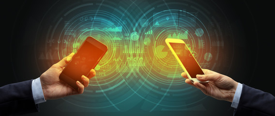 Close up of two smartphones syncing business data