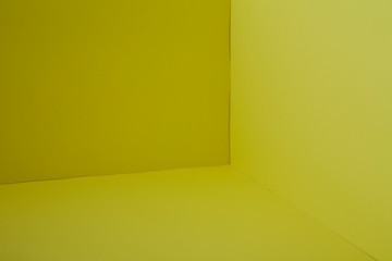 Empty corner yellow room with light from window
