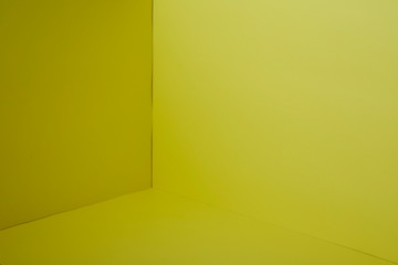 Empty corner yellow room with light from window