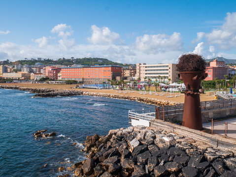 Naples, Campania, Italy: panorama of the beach of Bagnoli with an artistic steel installation, an area reclaimed from the remains of former Italsider steelworks
