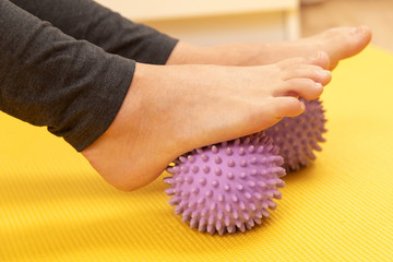 Female feet and prickly massage balls