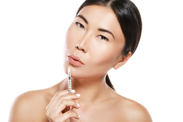 Asian woman during lips augmentation procedure.
