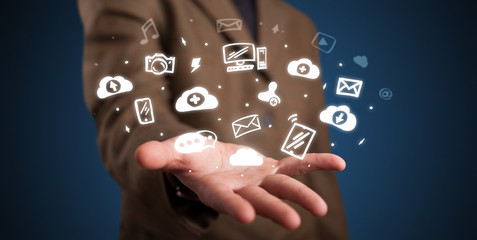 Hand holding application icons and symbols in her hand

