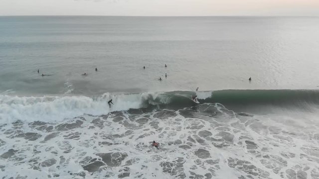 aerial video of surfer catching a wave in Kuta Beach, Bali