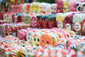 Tasty colorful lollipops different shapes on the counter fair