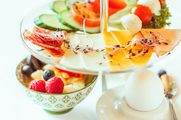 Breakfast. Snacks. Beautifully served breakfast of cheese, eggs, ham, fruit and vegetable salad