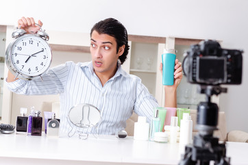 Young handsome man recording his blog in hygiene concept 