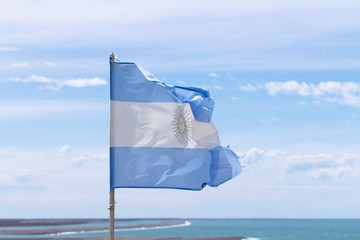 Argentina flag with atlantic ocean in background
