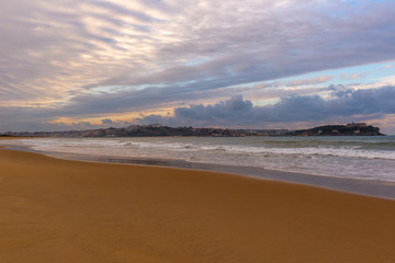 Fototapeta na wymiar El Puntal beach at sunset, bay of Santander, Spain