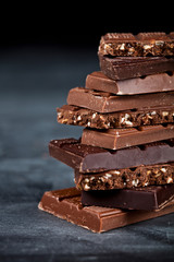 Chocolate bar pieces closeup. Sweet food photo concept with copy space.