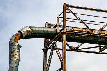 Abandoned industrial complex, rusted and broken pipes and construction