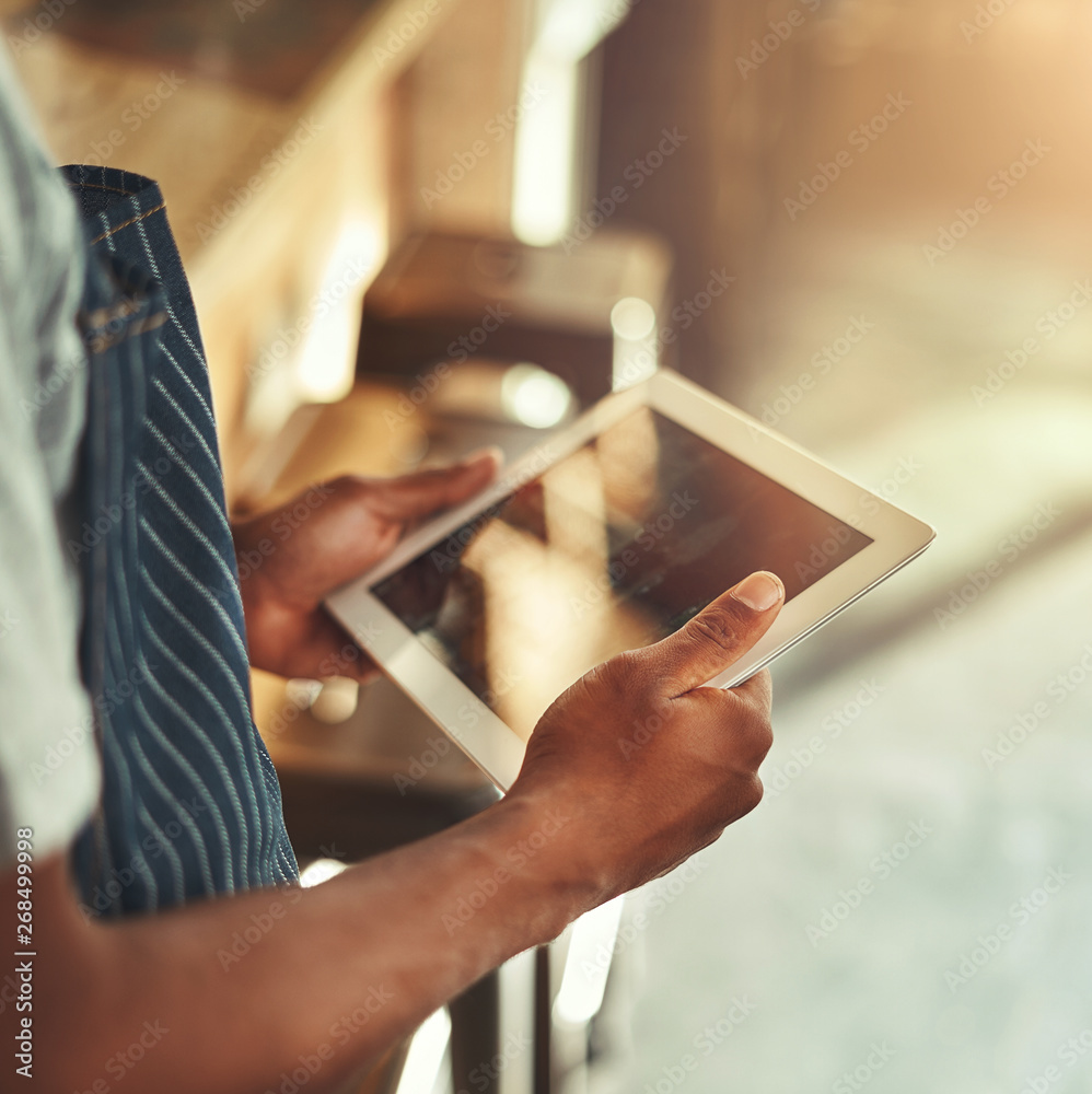 Wall mural cafe owner holding digital tablet in hands