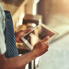 Cafe owner holding digital tablet in hands