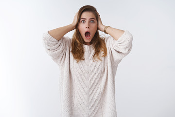 Studio shot stunned speechless shocked woman drop jaw gasping shook grab head stupified realising left oven on, panicking looking anxious bothered troubled, standing white background