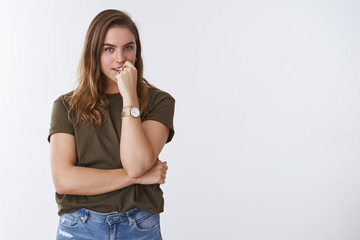 Devious creative intrigued charming european woman have plan thinking biting finger looking mysterious thoughtful, gazing desirable thing, standing curious white background wearing casual clothes - obrazy, fototapety, plakaty