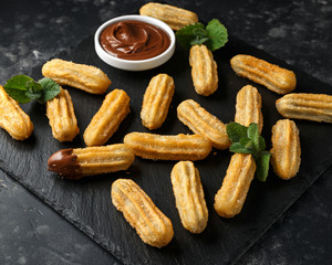 Churros with chocolate dipping sauce. sugar and cinnamon.