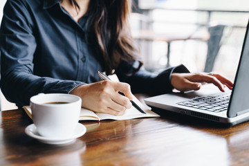 Businesswoman working at the coffee shop with laptop computer. Business financial analysis and strategy concept.