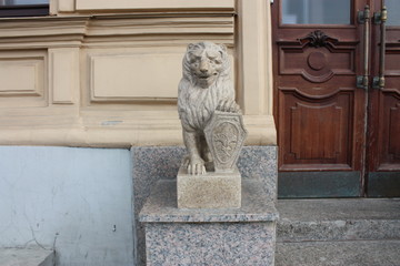 statue of a stone lion near the historic building