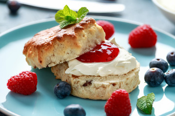 Classic English scones with clotted cream, strawberries jam and other fruit