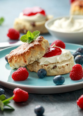 Classic English scones with clotted cream, strawberries jam and other fruit