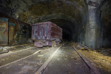 Fototapeta na wymiar Underground mineshaft gold iron ore tunnel with orecar mine car