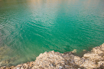 Open pit mining gold quarry with blue water