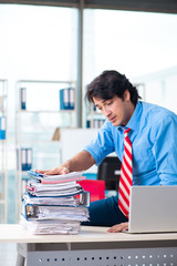 Handsome businessman unhappy with excessive work in the office 