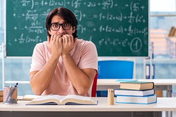 Young male student in the classroom 