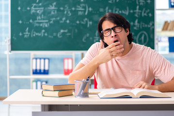 Young male student in the classroom 