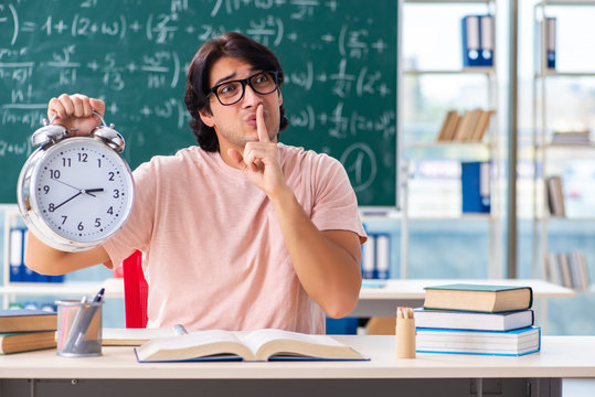Young male student in the classroom 