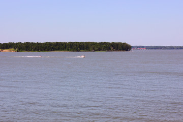 two motor boats float on the river