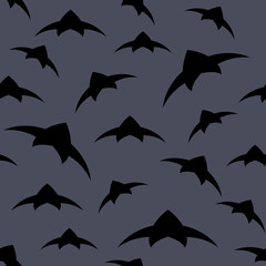 A flock of birds in the sky. Seamless pattern. Dark vector background