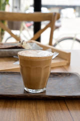 Hot latte on a wooden table