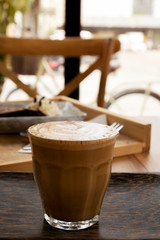 Hot latte on a wooden table