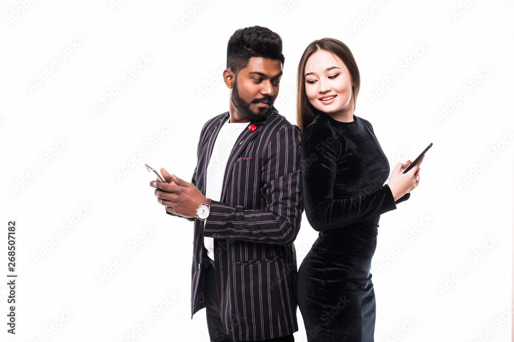 Wall mural beautiful, pretty, cute asian woman and handsome indian man standing back to back and writing sms th