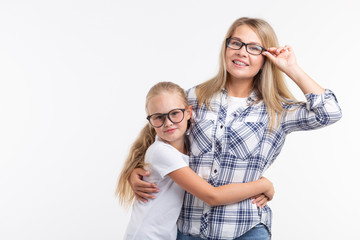 Happy young mother and laughing kid in fashion glasses have fun on white background