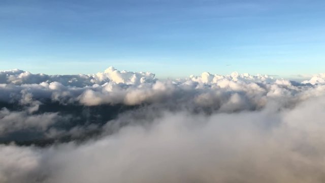 Sunrise through the fog on Mount Batur over lake Batur, Volcano Agung, Bali. Cinematic scene of the passage of clouds in the valley of the volcano above the lake