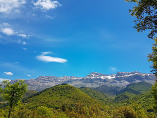 Fototapeta premium spring in mountain Tzoumerka green hills blue sky,village Lepiana , Arta perfecture Greece