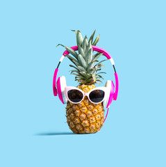 Pineapple wearing headphones on a solid color background